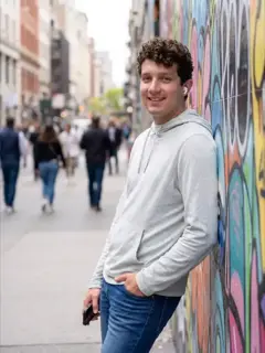 AI-generated dating photo leaning against a colorful graffiti wall on a city street